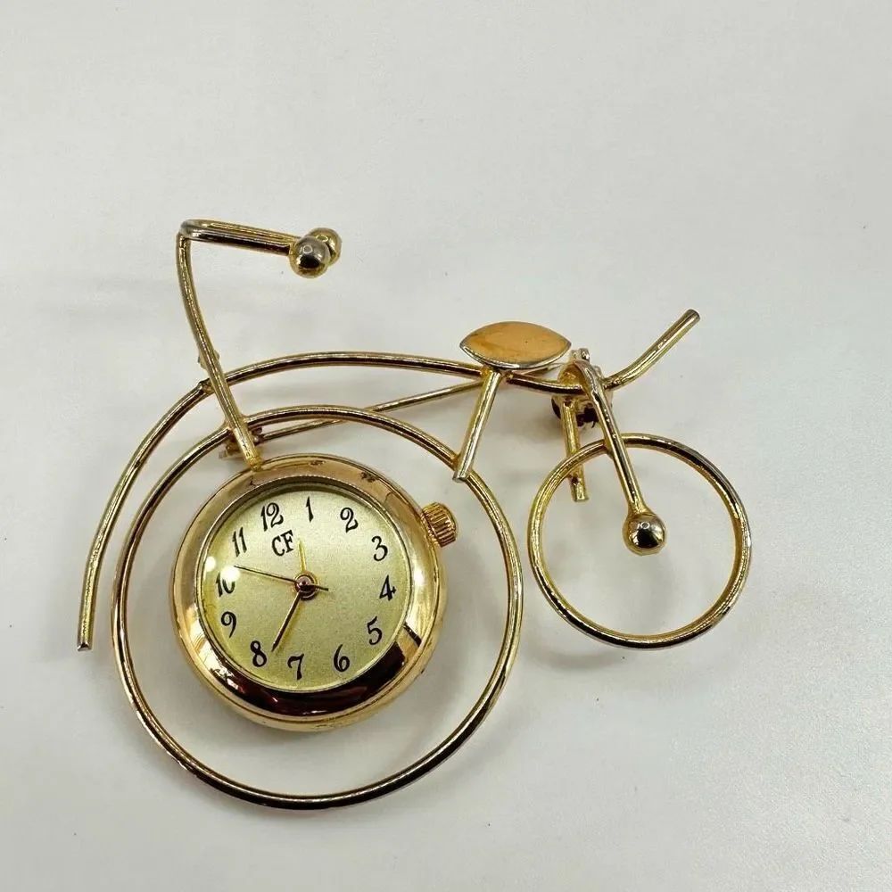 CF Gold tone watch bicycle brooch